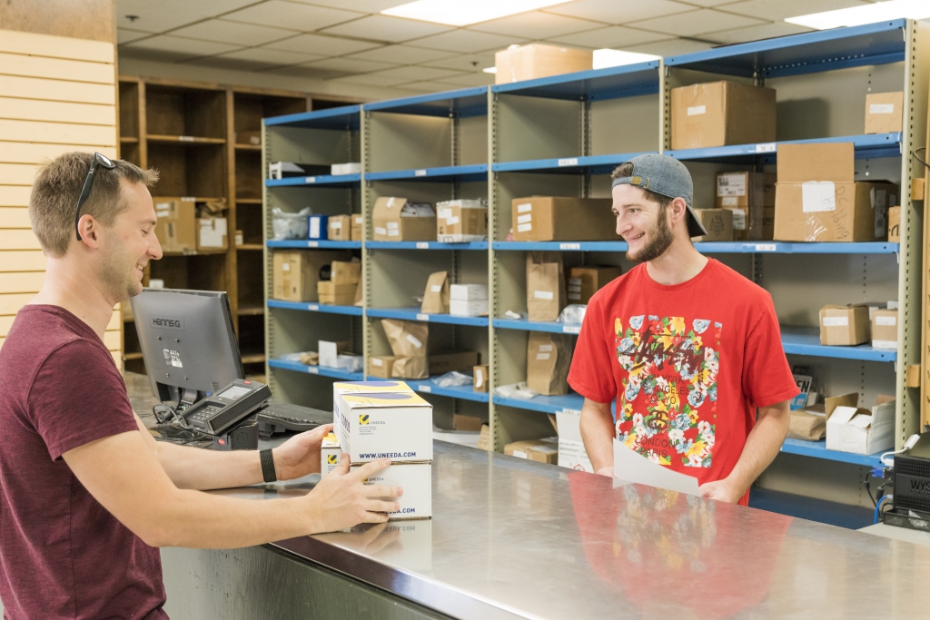 Joe from a neighboring shop, Creative Woodworking picks up an order